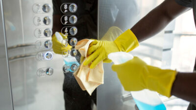Hands cleaning elevator buttons - www.freepik.com